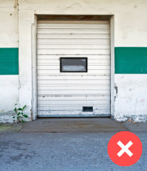 White cargo door with window in wall with green stripe