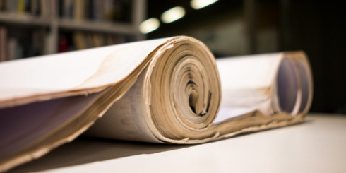 Rolled documents on table